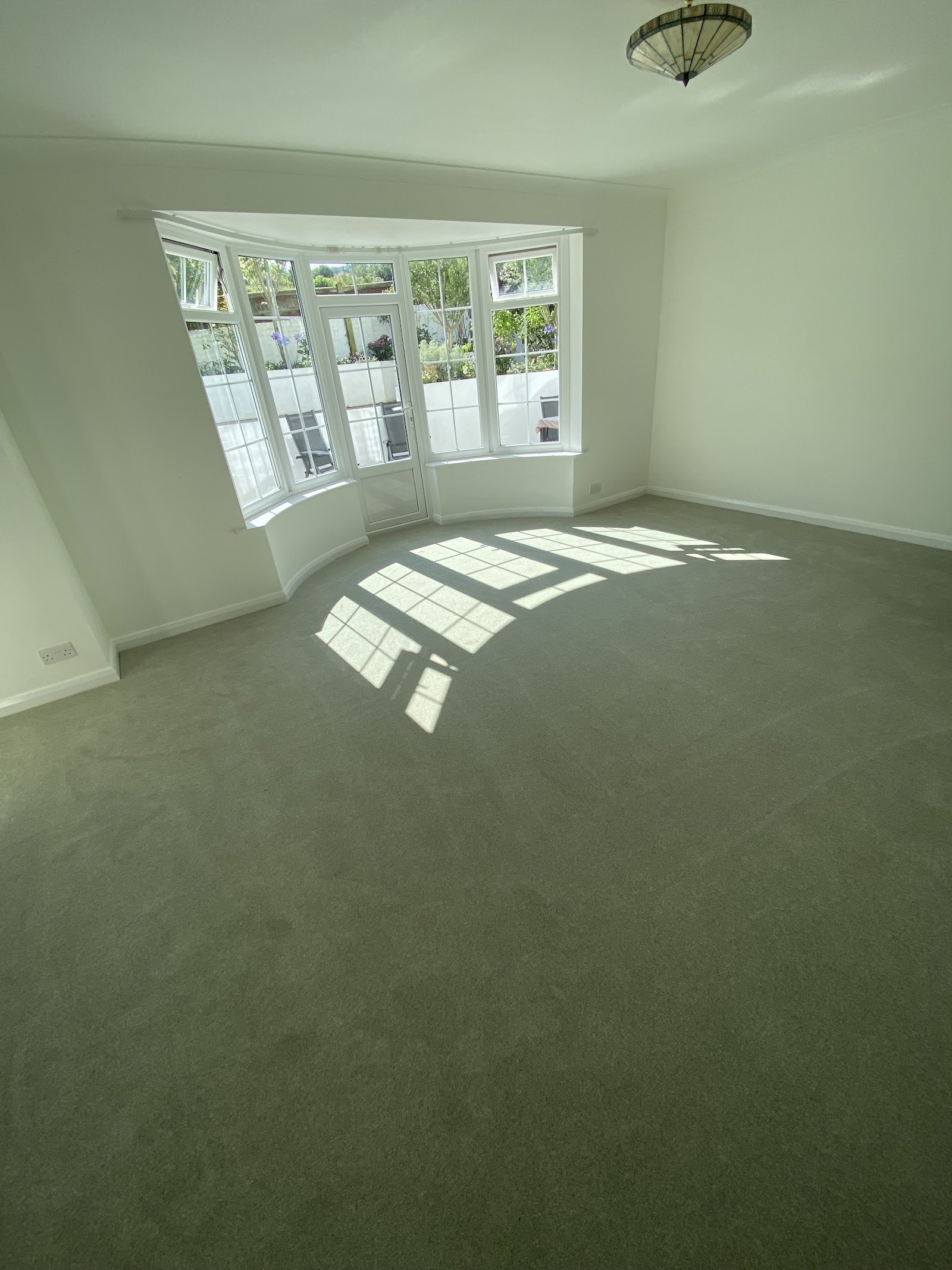 Grey carpet in a lounge with a large bay window