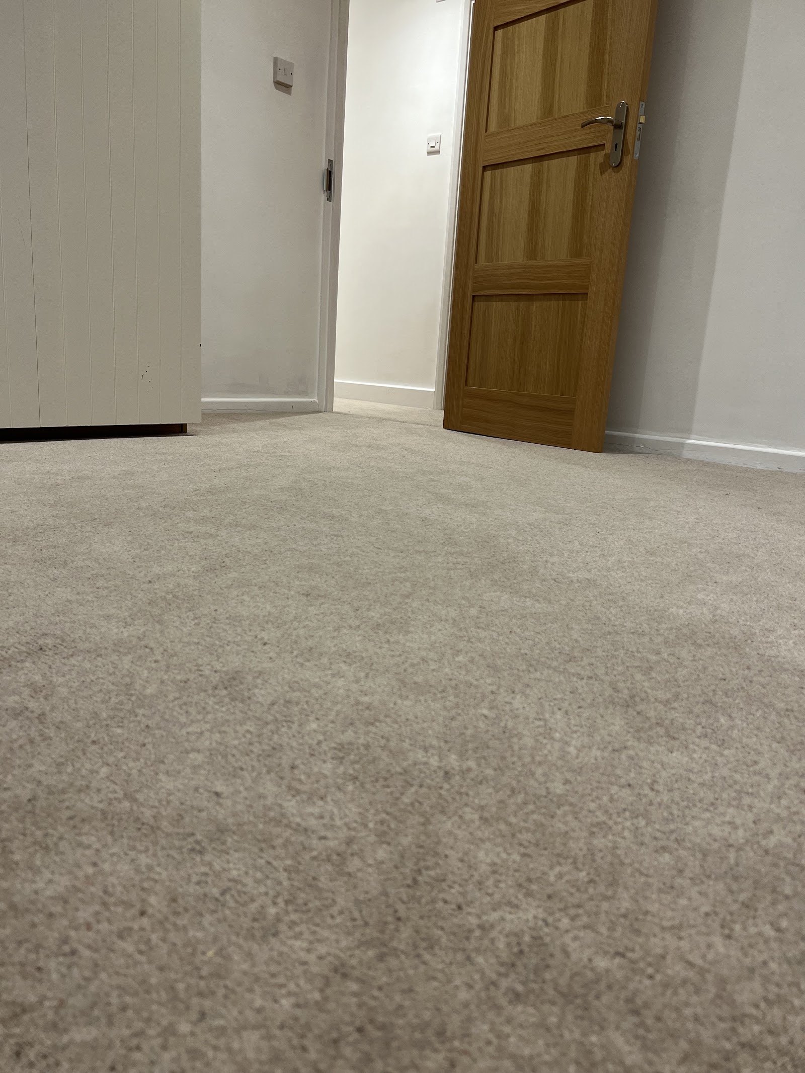 Soft beige carpet in a hallway with oak doors