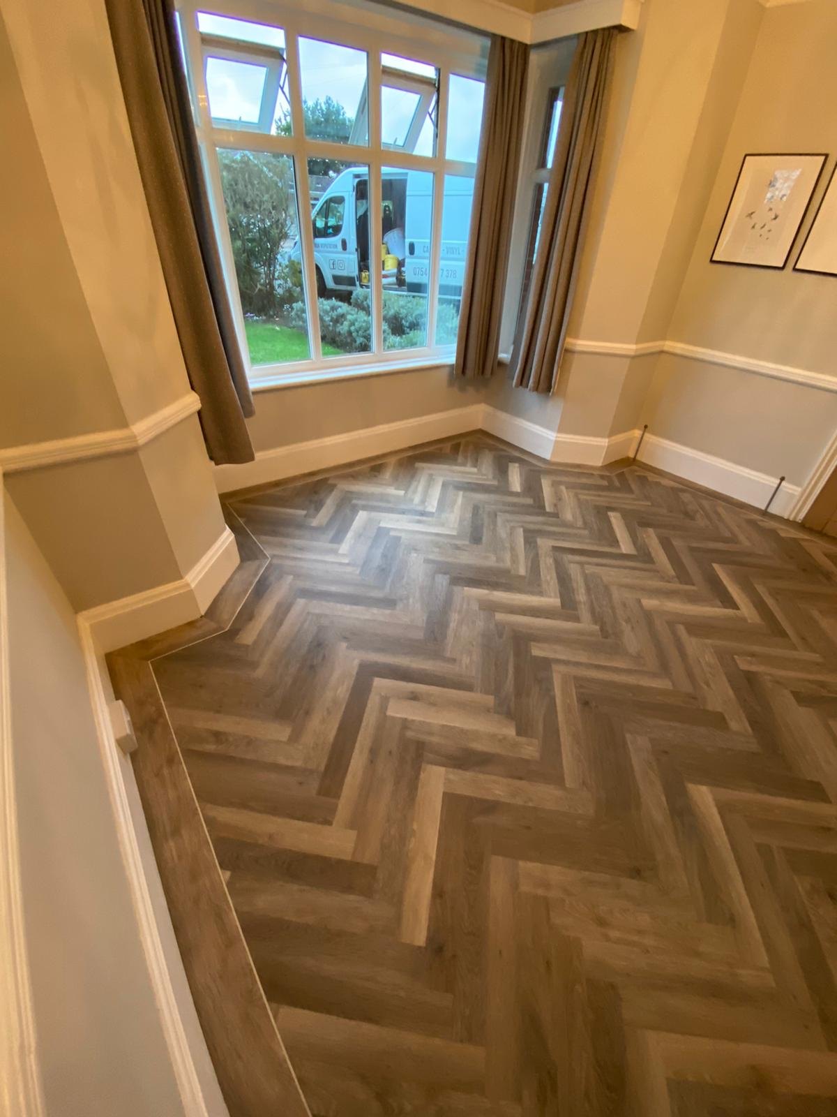 Herringbone floor curving into a bay window