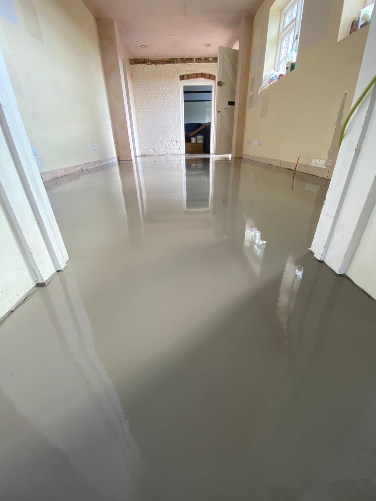 Self-levelling screed curing along a long room
