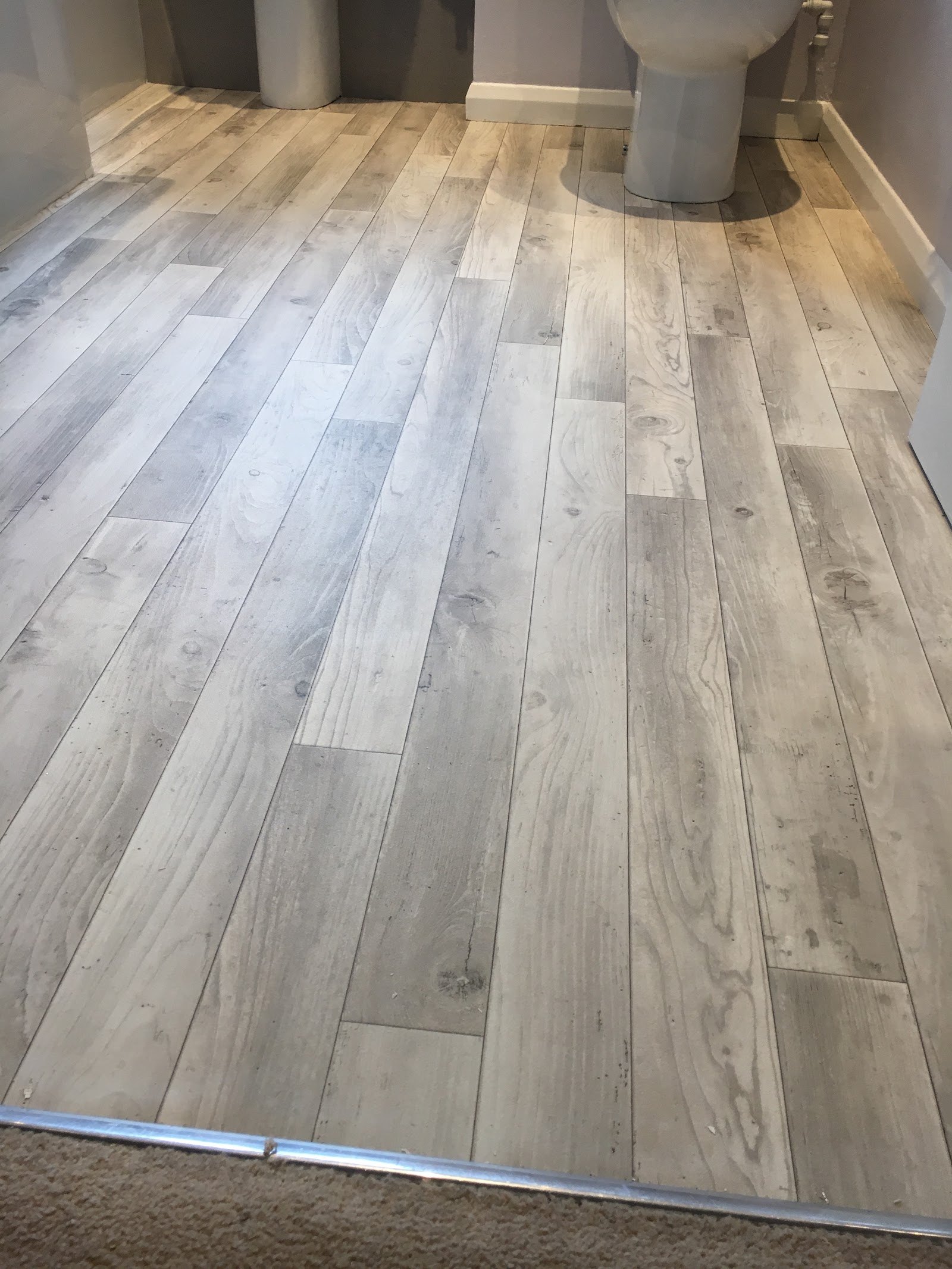 Grey plank vinyl in a cloakroom