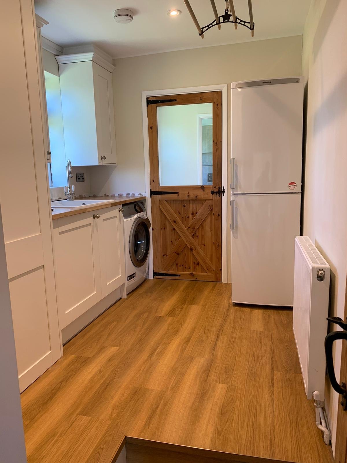 Wood-effect floor in a cottage kitchen with a stable door