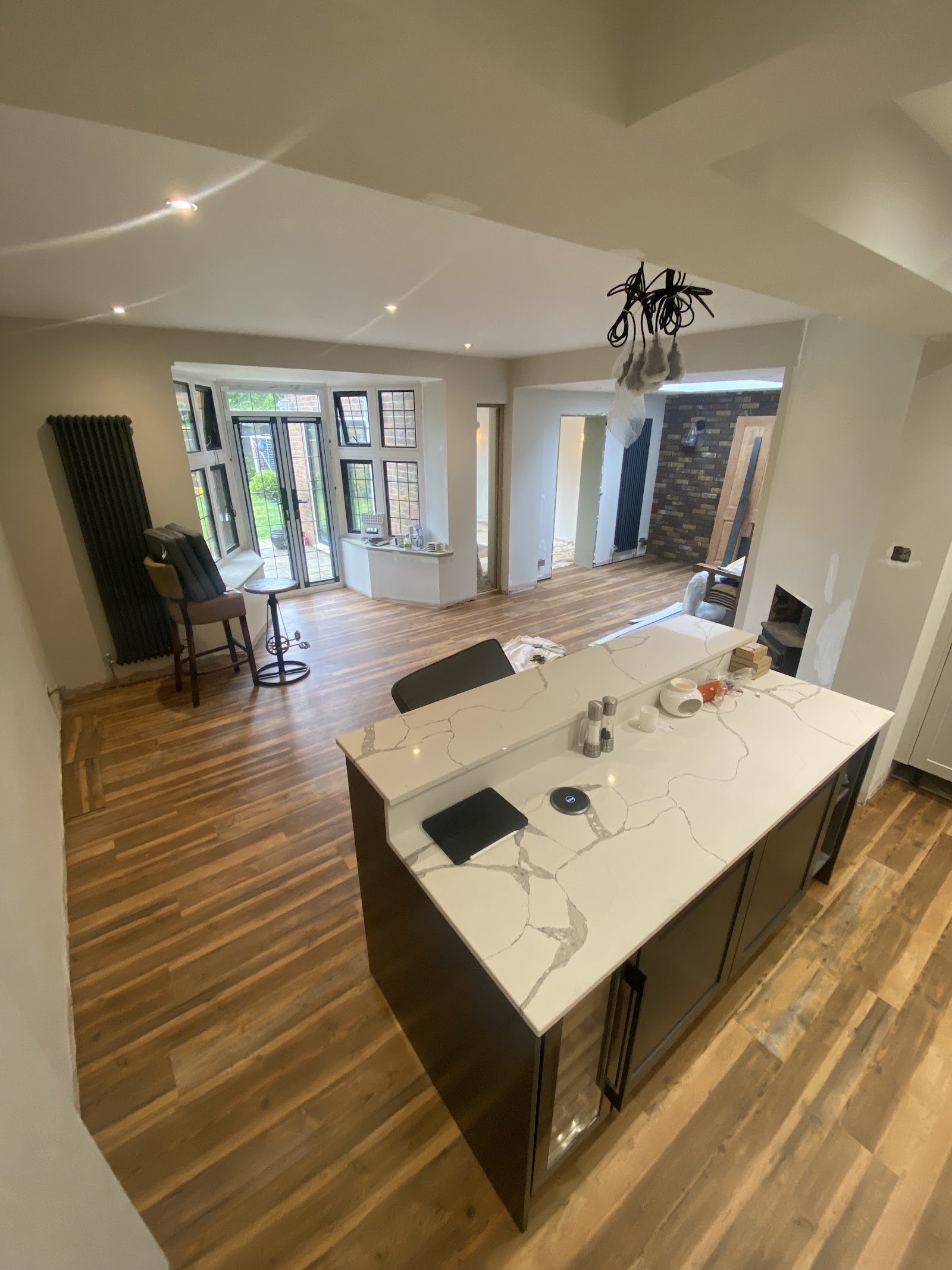 Open-plan kitchen and dining room with rustic wood-effect flooring
